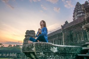 Young,Woman,Meditating,And,Doing,Yoga,,Angkor,Wat,Temple,,Cambodia